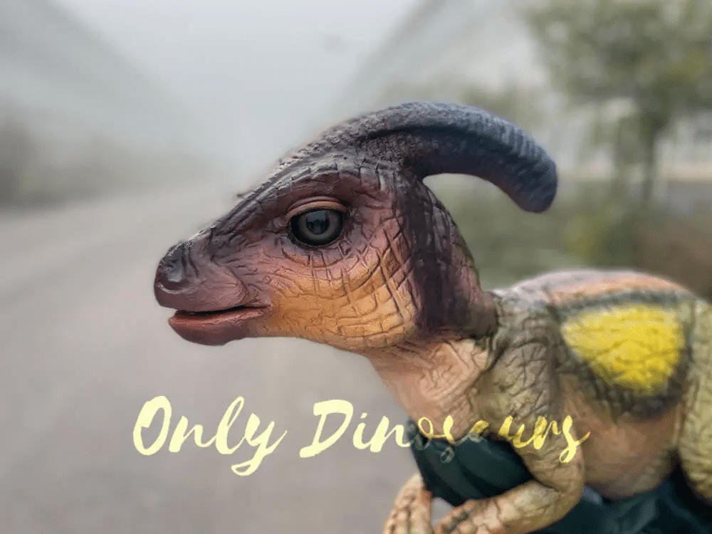 a somewhat picture of a lifelike baby dinosaur puppet from the swith a logo that reads "only dinosaurs"